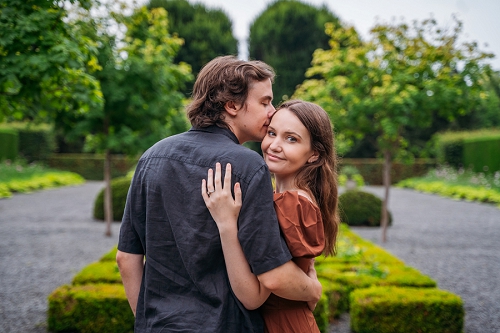  fiance kissing her forehead while she looks at camera