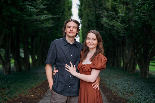 portrait of couple smiling at camera at the botanical gardens in niagara falls 