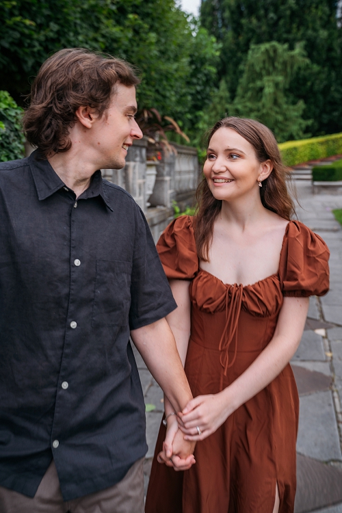  couple walking while she's smiling at him