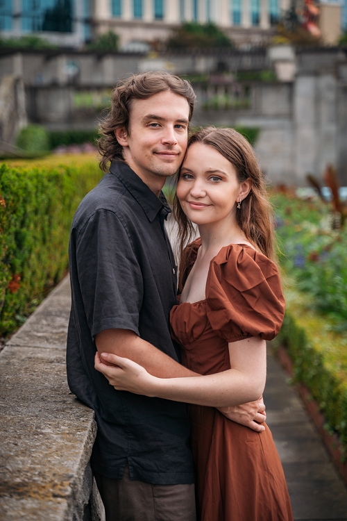 engagement portrait at oakes garden theatre where couple is smiling at camera 