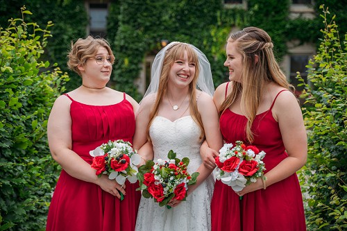 bride and bridesmaids laughing 