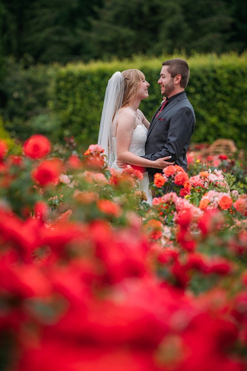 bride and groom in rose garden at botanical gardens