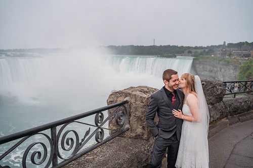 bride and groom laughing in the rain