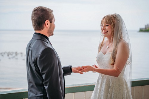 bride and groom smiling during ceremony