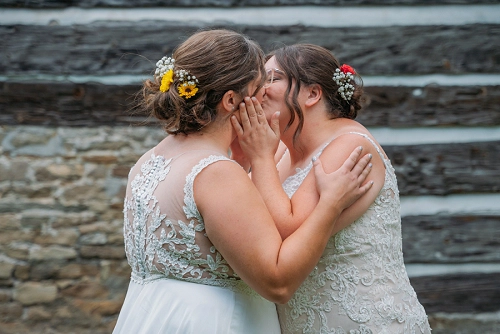 two brides kissing