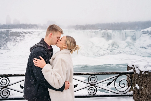  proposal in front of niagara falls in the winter