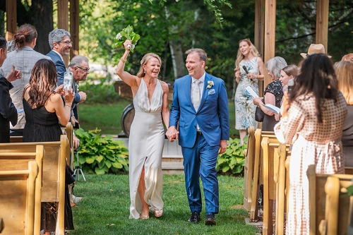  bride and groom walking down aisle