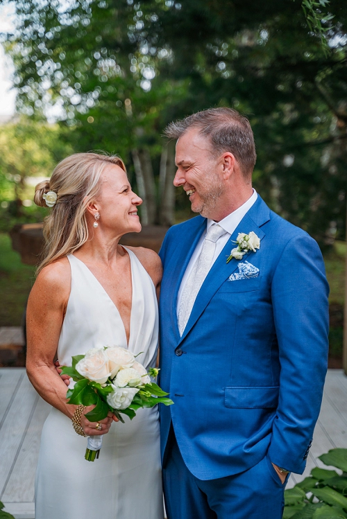 bride and groom smiling at each other 