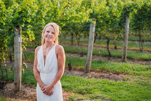  portrait of bride in front of vineyard at Honsberger Estate Winery