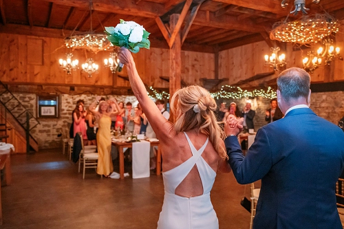  bride and groom entering reception at Honsberger Estate Winery