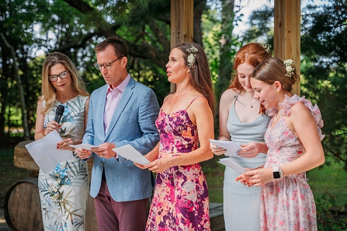 Wedding guests singing as bride walks down the aisle