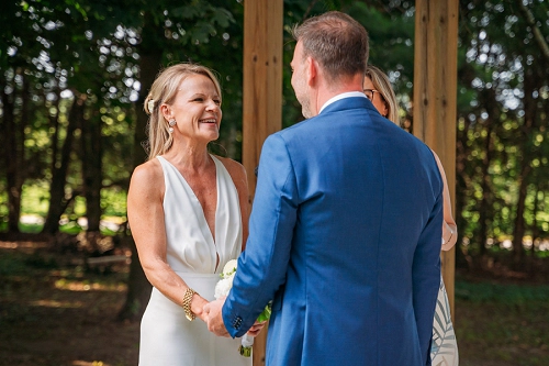  bride smiling at groom during ceremony