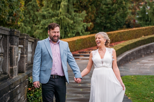 bride and groom holding hands and laughing