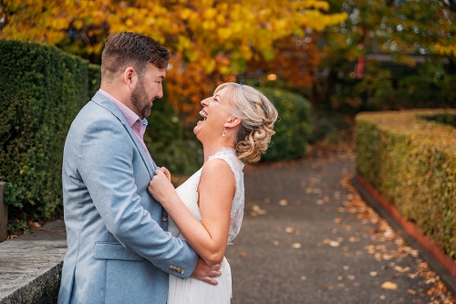  bride laughing while groom is holding her