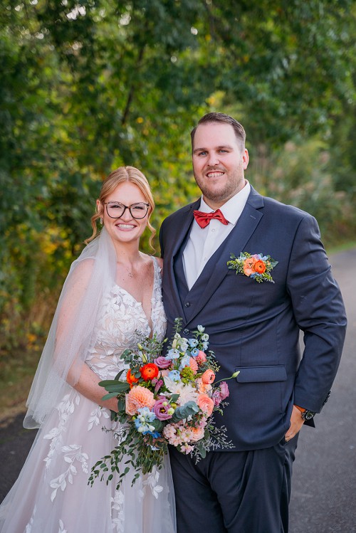 portrait of bride and groom smiling at camera