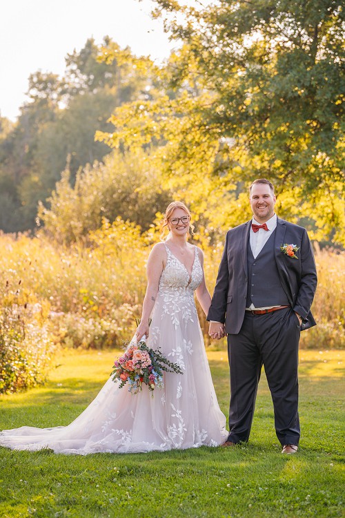 bride and groom smiling and holding hands