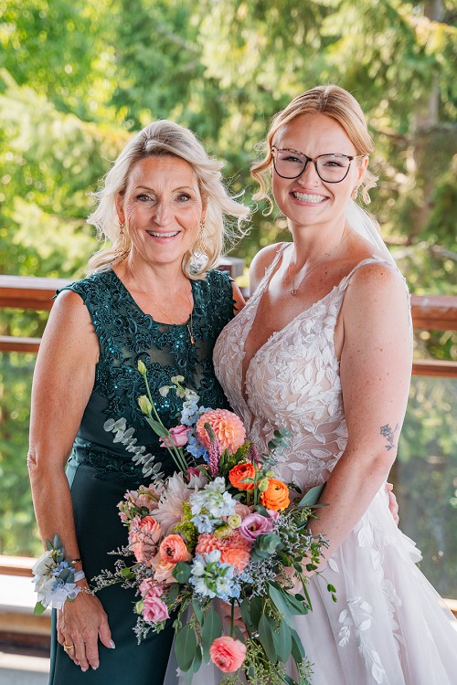 bride with mom smiling at camera