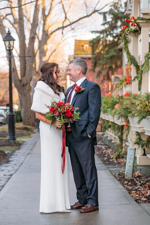  bride and groom smiling at each other surrounded by christmas decorations