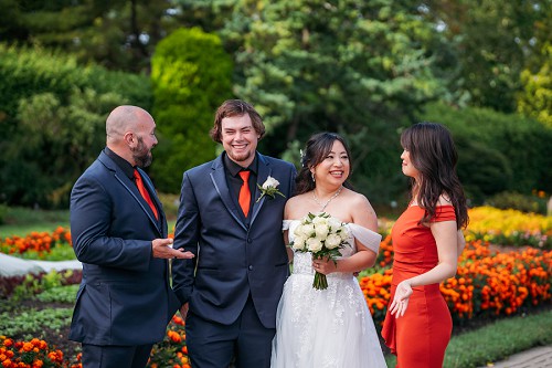 candid of bride and groom laughing with guests