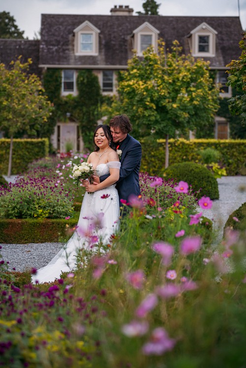 bride and groom surrounded by flowers