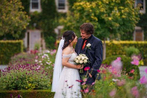 couple surrounded by purple flowers