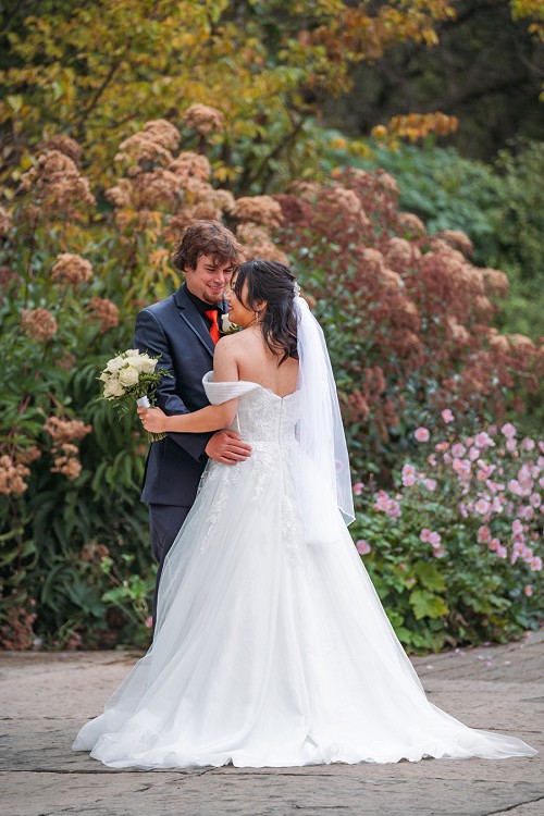 bride from behind while groom is smiling