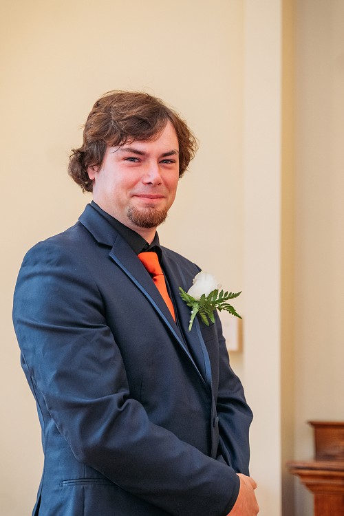 groom smiling at bride