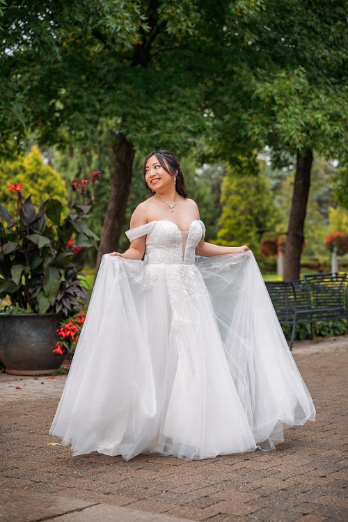 bride laughing while playing with her dress