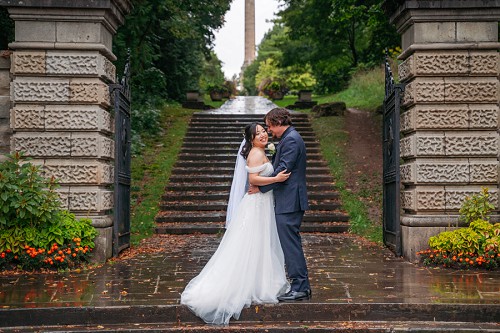 bride and groom kissing on staircase