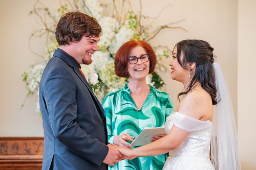 bride and groom smiling during ceremony