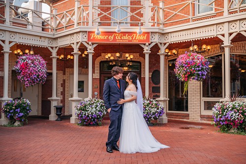 wedding portrait in front of princes of wales hotel in niagara on the lake