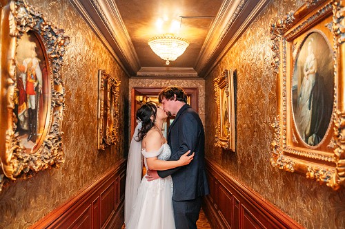 bride and groom kissing in hallway at prince of wales hotel