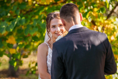  bride smiling at groom during ceremony