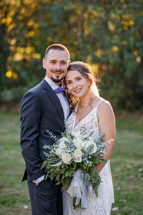  bride and groom smiling at camera