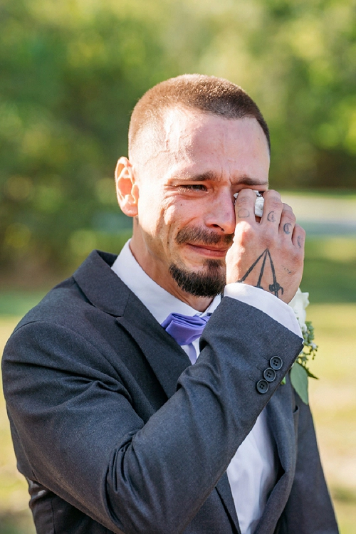  groom crying as bride walks down aisle