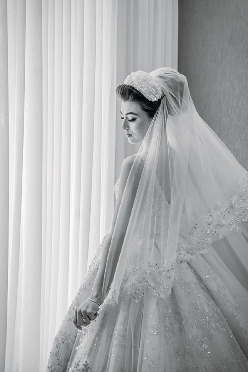 bride standing at window 