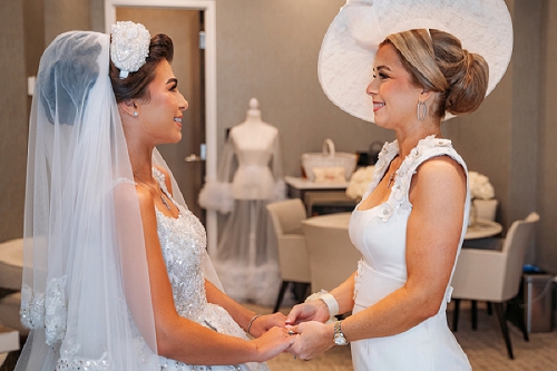 bride and mom holding hands 