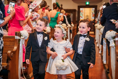 flower girl and ring bearers walking down aisle 