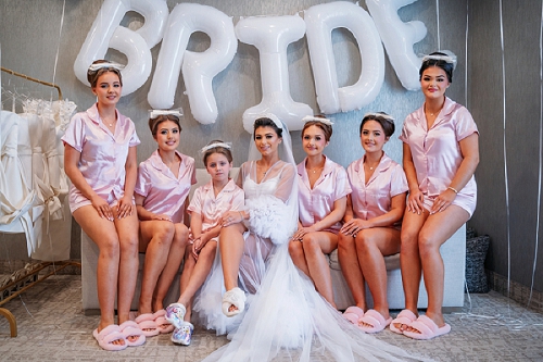 bridesmaids smiling with balloons behind them 