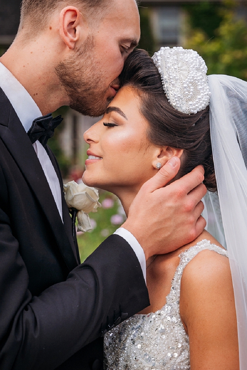  romantic groom kissing bride on forehead