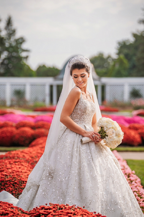 bride laughing in field of flowers 