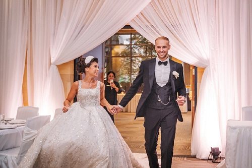 bride and groom entering reception at white oaks 