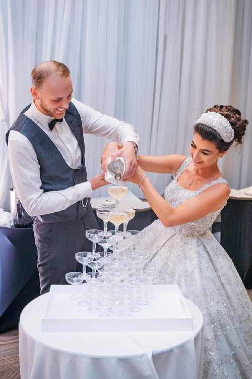  bride and groom pouring champagne fountain