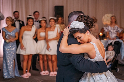  bride hugging father while dancing